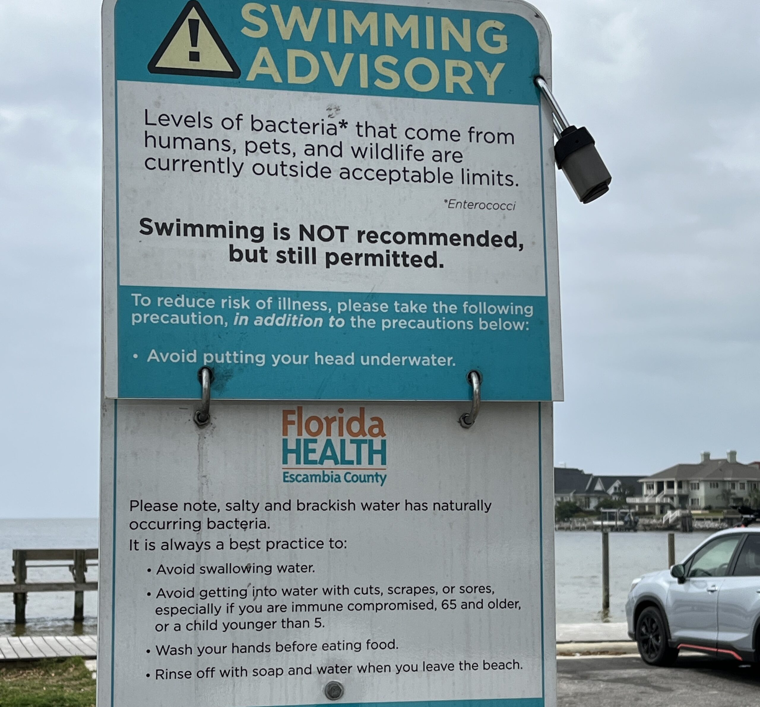 Photo of a FDOH beach advisory sign stating swimming is not recommend. 